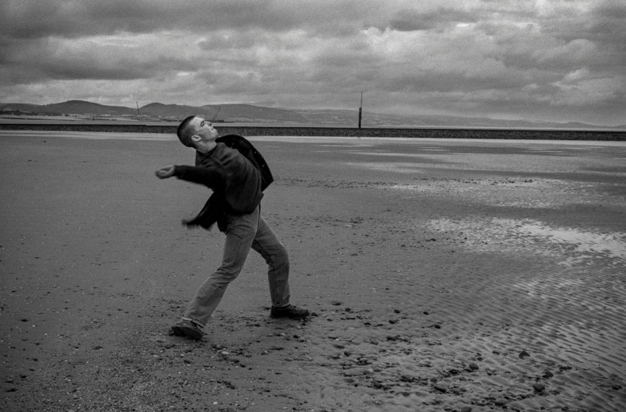 Throwing Stones on Beach, Llandudno, 1992 From British Coastal Resorts - Photographic Essay by Christopher John Ball Throwing Stones on Beach, Llandudno, 1992 From British Coastal Resorts - Photographic Essay by Christopher John Ball